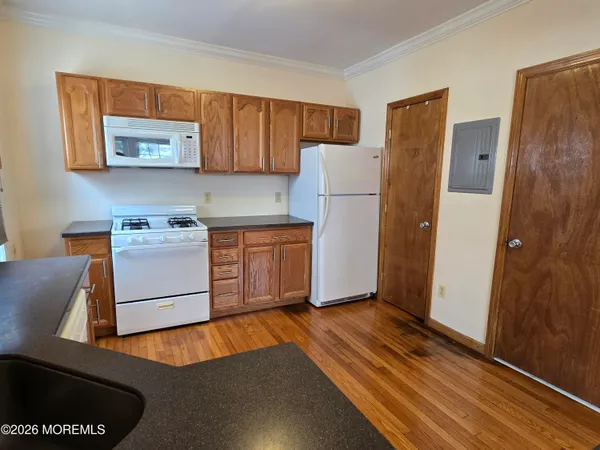 a kitchen with a refrigerator and a stove top oven