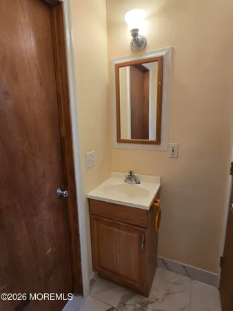 a bathroom with a sink a mirror and vanity