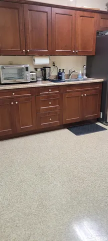 a room with granite countertop stainless steel appliances and cabinets