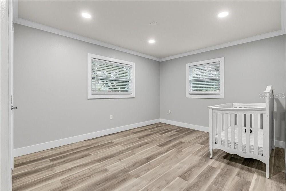 5804 Wolf Road Orlando, FL 32808 - Photo 20 of 24 a view of an empty room with wooden floor and a window