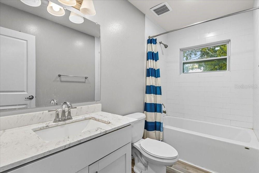 5804 Wolf Road Orlando, FL 32808 - Photo 23 of 24 a bathroom with a sink a toilet and shower