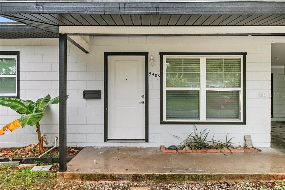 5804 Wolf Road Orlando, FL 32808 - Photo 3 of 24 a front view of a house with a yard