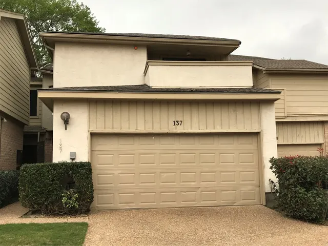 a front view of a house with garage