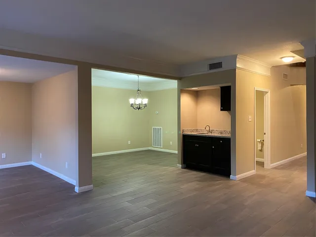a kitchen with stainless steel appliances granite countertop a refrigerator stove and a sink