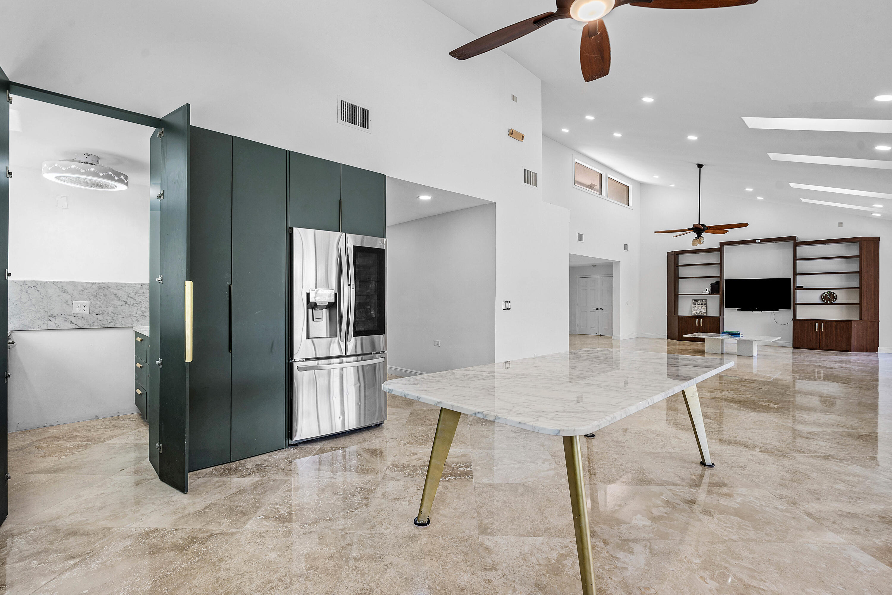 10391 Boca Woods Lane Boca Raton, FL 33428 - Photo 12 of 60 a kitchen with stainless steel appliances kitchen island granite countertop a refrigerator and a stove top oven