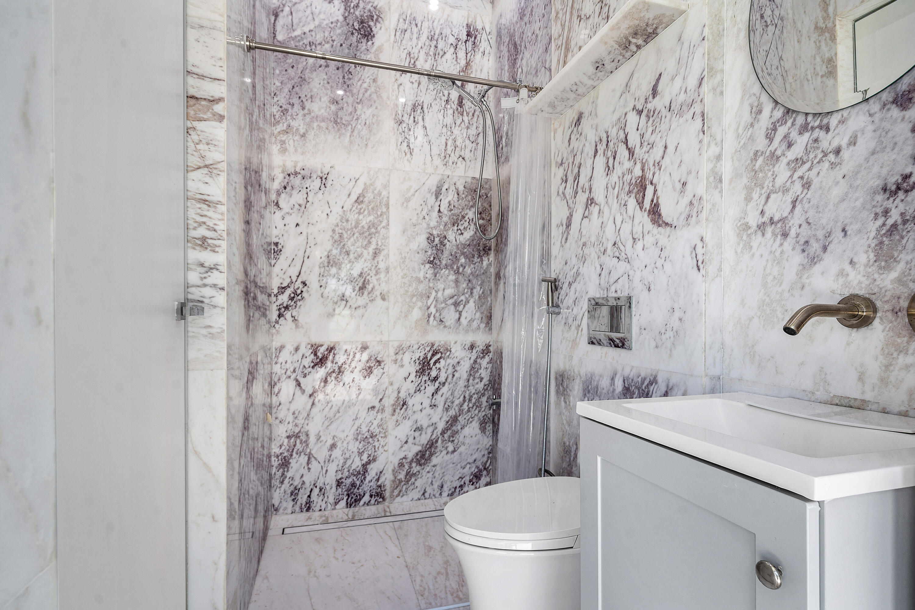 10391 Boca Woods Lane Boca Raton, FL 33428 - Photo 16 of 60 a bathroom with a toilet sink and shower