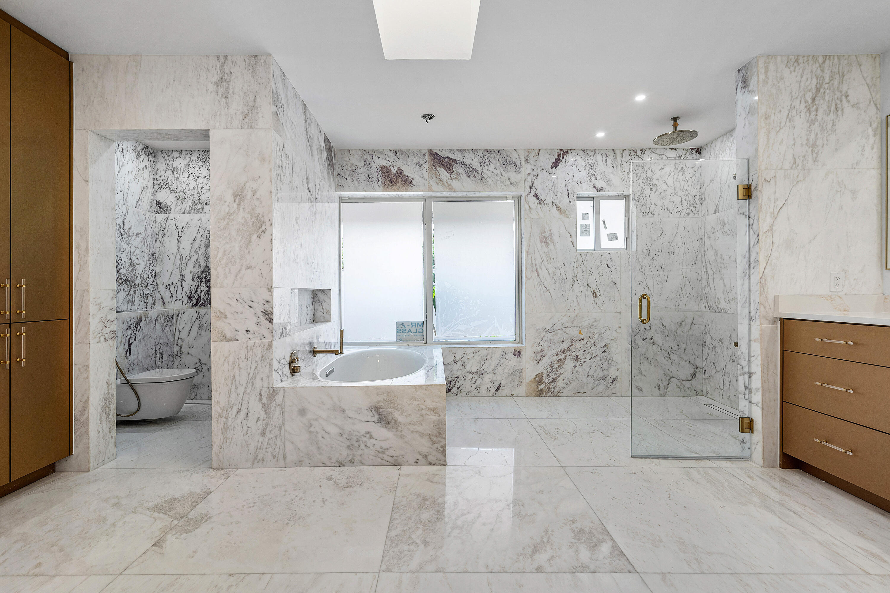 10391 Boca Woods Lane Boca Raton, FL 33428 - Photo 20 of 60 a bathroom with a granite countertop sink a toilet and shower