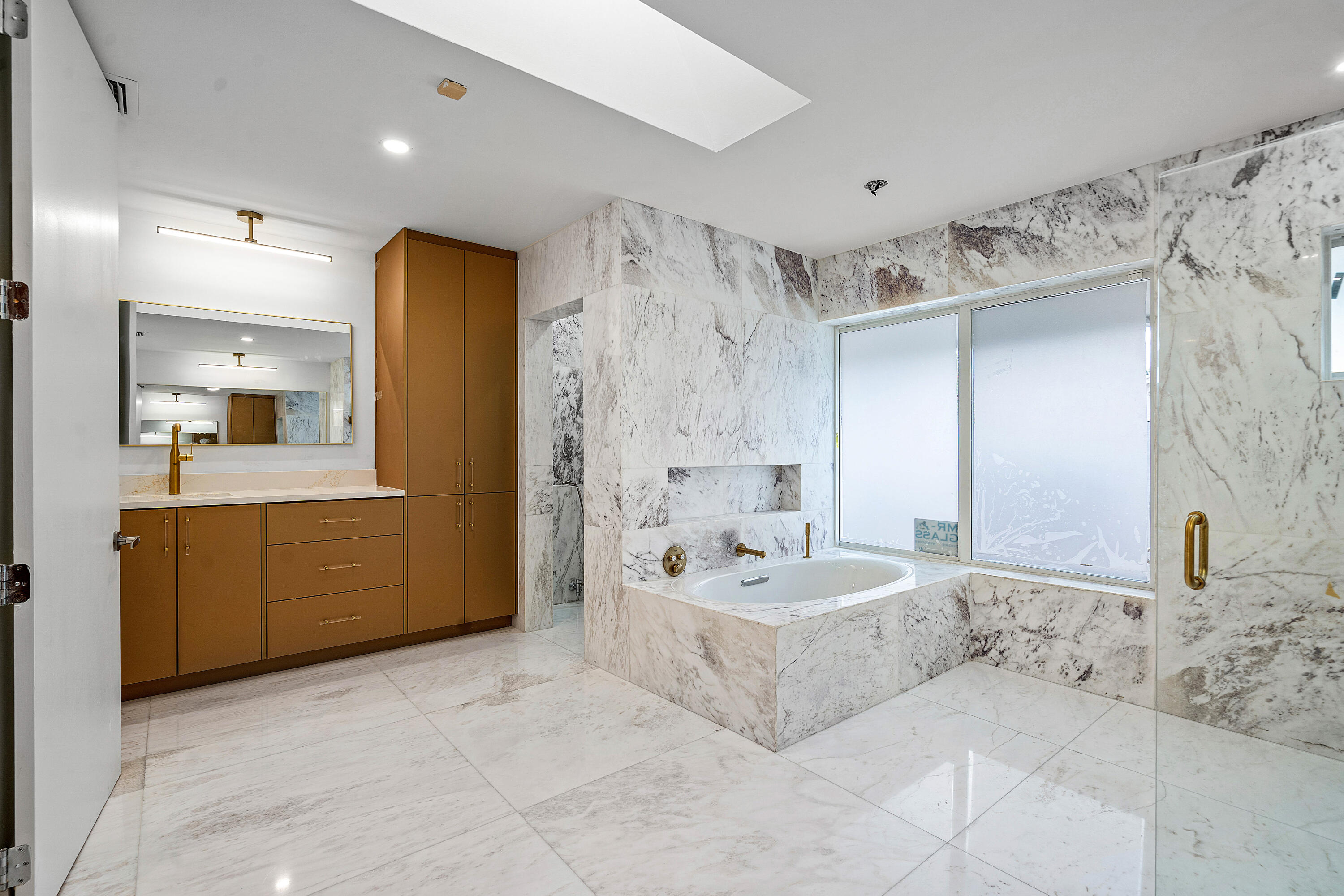 10391 Boca Woods Lane Boca Raton, FL 33428 - Photo 21 of 60 a spacious bathroom with a double vanity sink mirror and bathtub