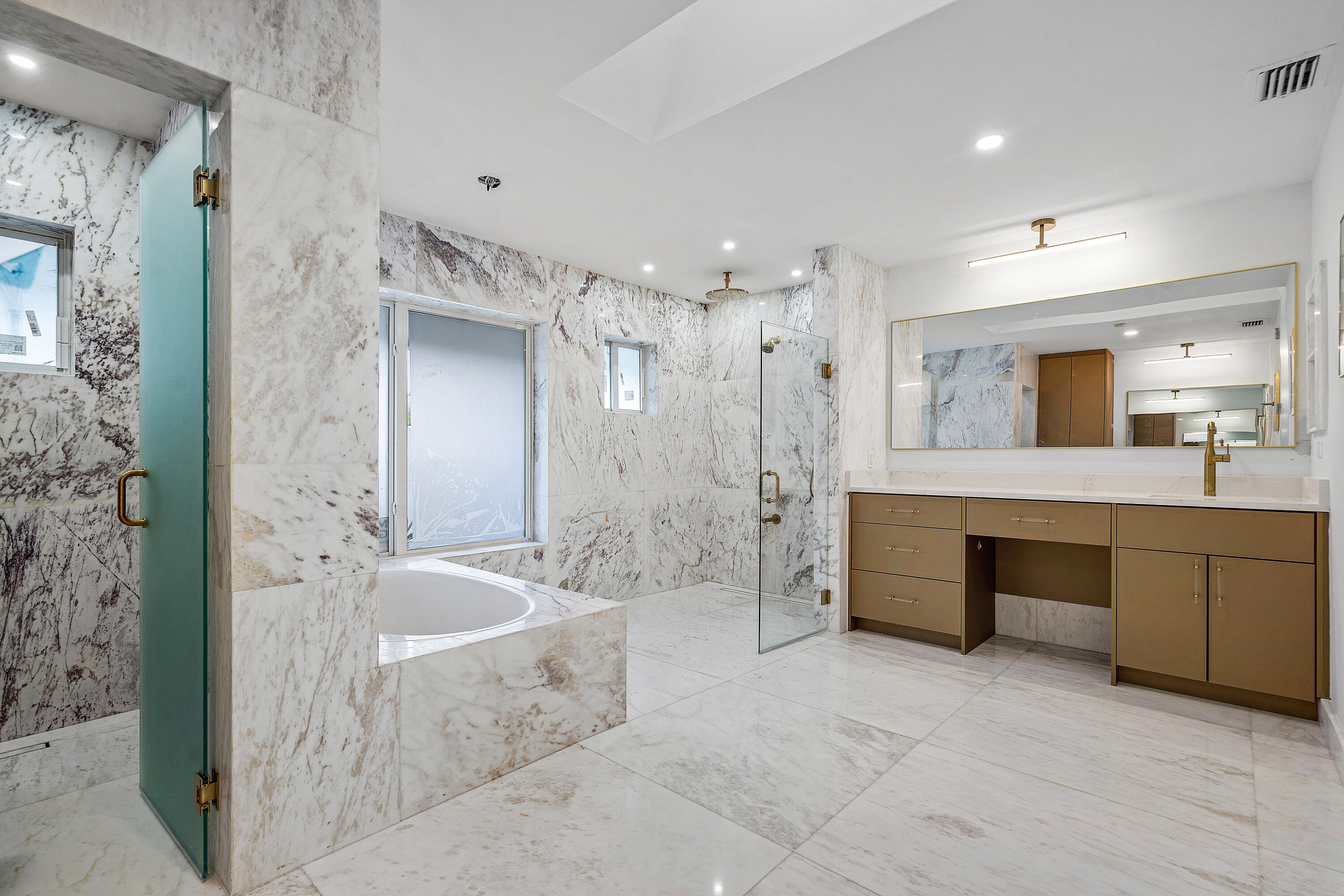 10391 Boca Woods Lane Boca Raton, FL 33428 - Photo 22 of 60 a large spacious bathroom with a granite countertop tub sink shower and mirror