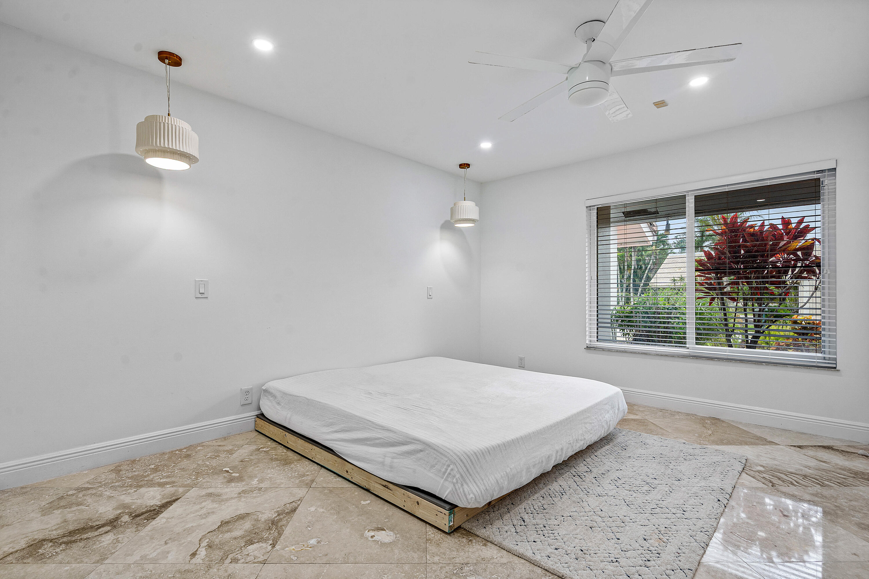 10391 Boca Woods Lane Boca Raton, FL 33428 - Photo 29 of 60 a spacious bedroom with a bed and a window