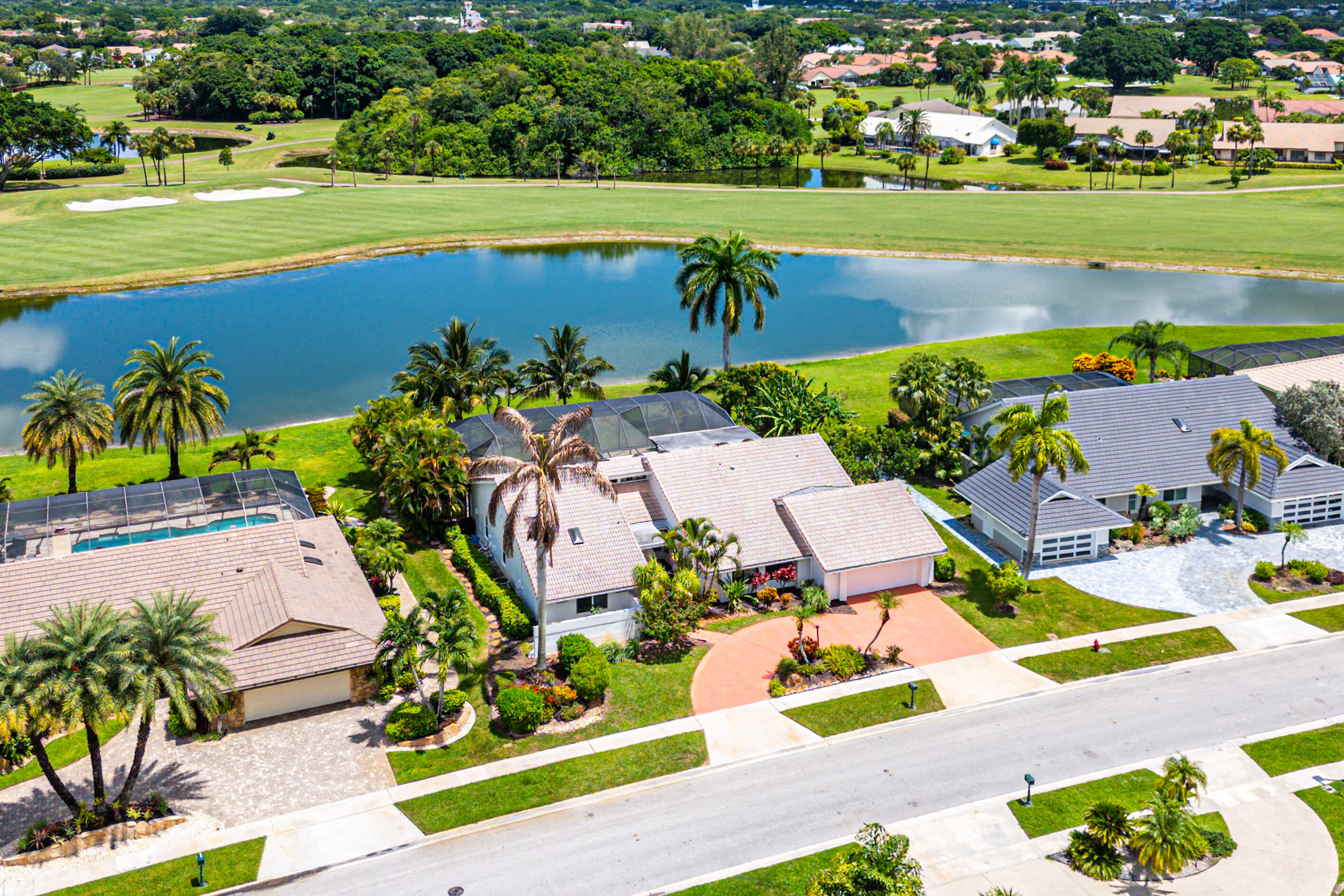 10391 Boca Woods Lane Boca Raton, FL 33428 - Photo 38 of 60 an aerial view of a house with a swimming pool yard and outdoor seating