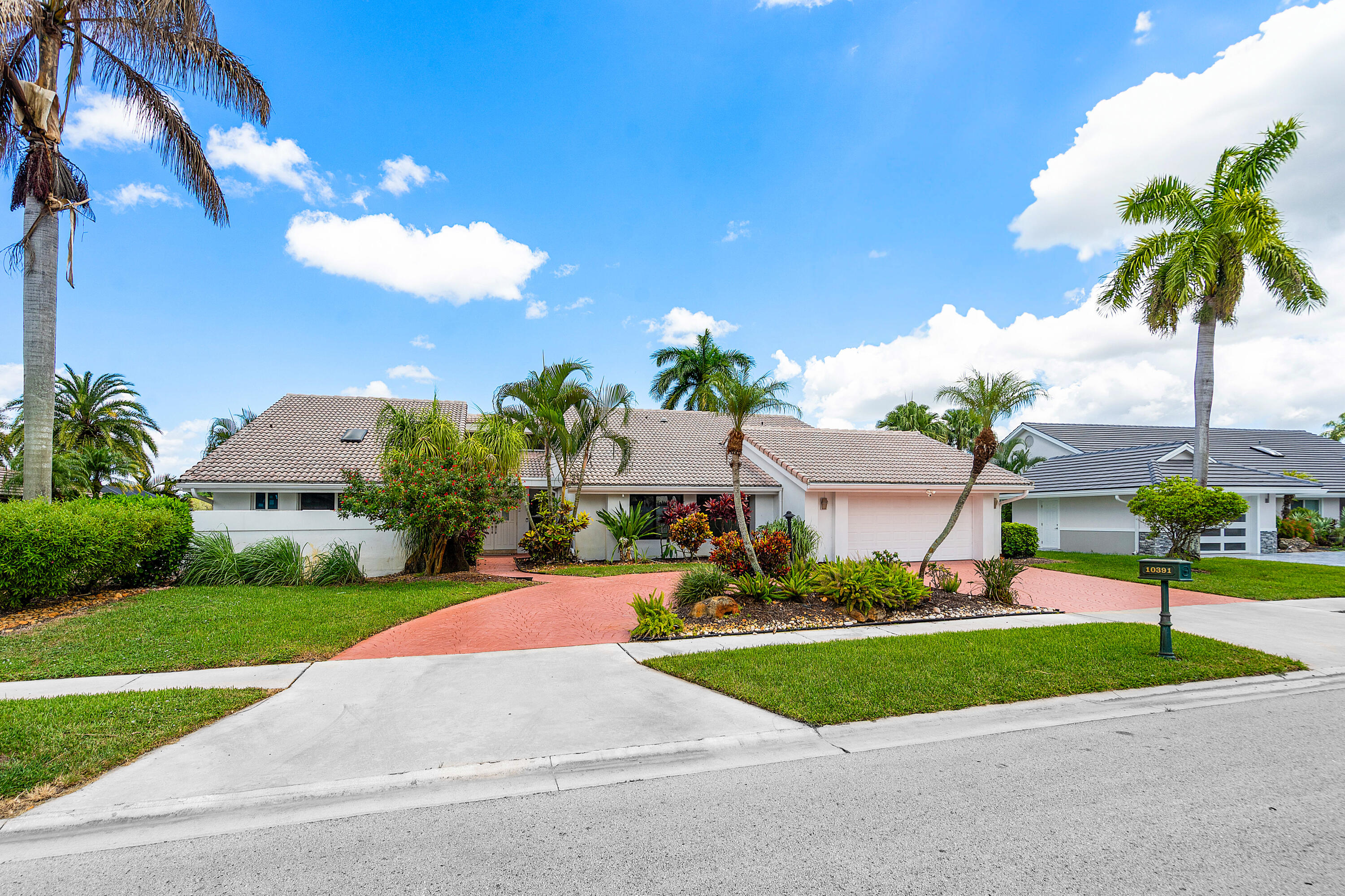 10391 Boca Woods Lane Boca Raton, FL 33428 - Photo 5 of 60 a view of a street with a house and a street view