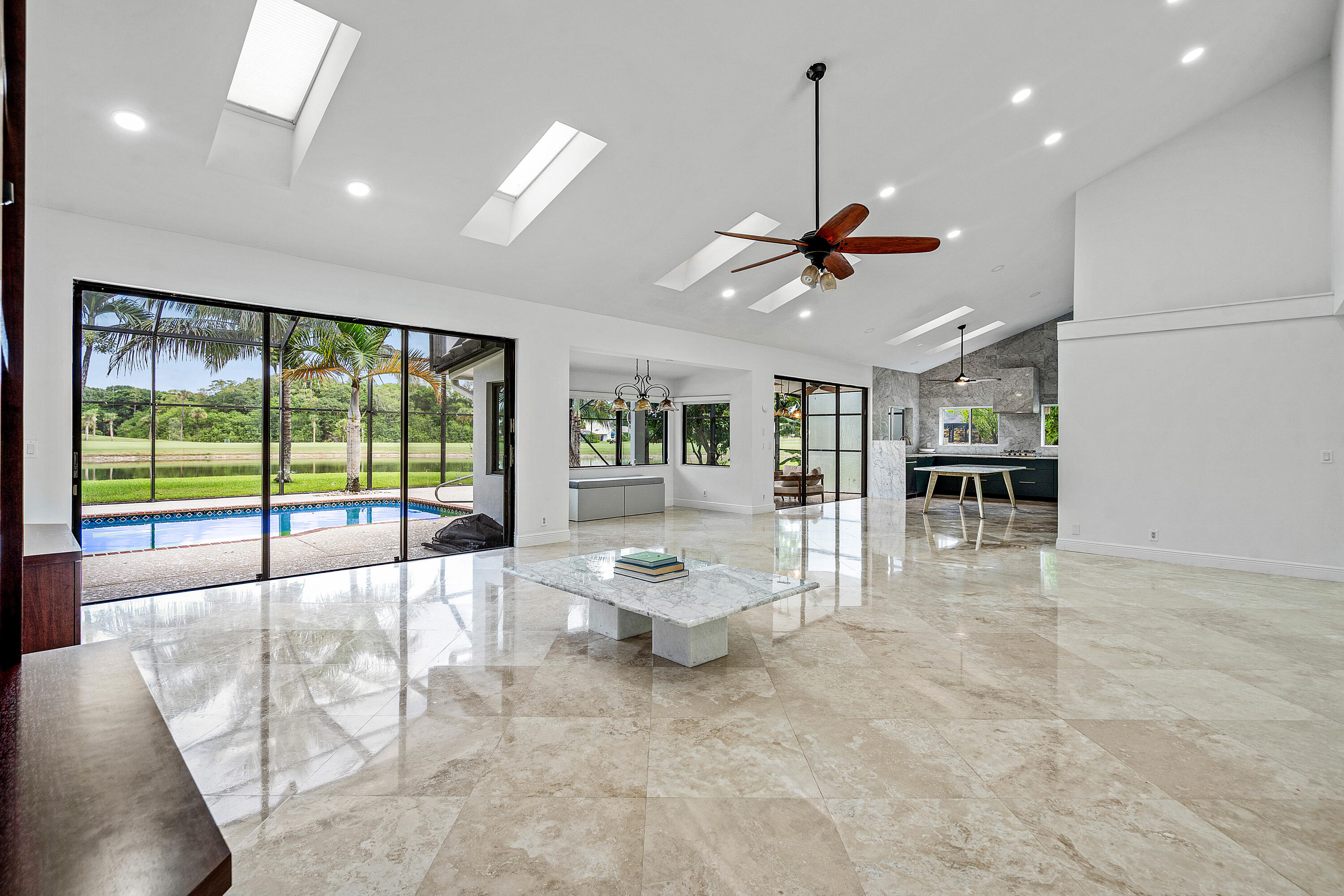10391 Boca Woods Lane Boca Raton, FL 33428 - Photo 8 of 60 a living room with furniture large window and a chandelier
