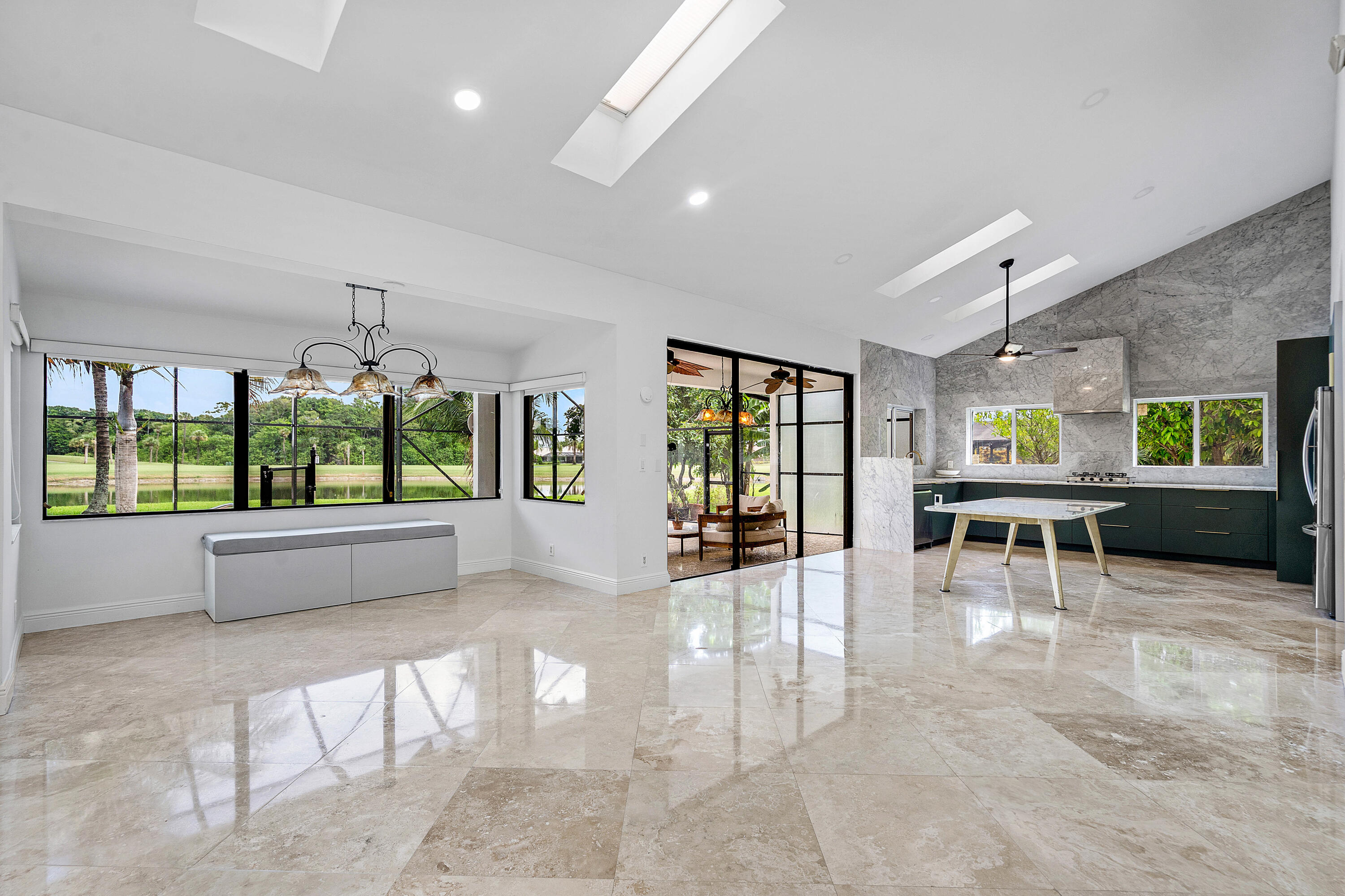 10391 Boca Woods Lane Boca Raton, FL 33428 - Photo 9 of 60 a view of an entryway with floor to ceiling windows and a table
