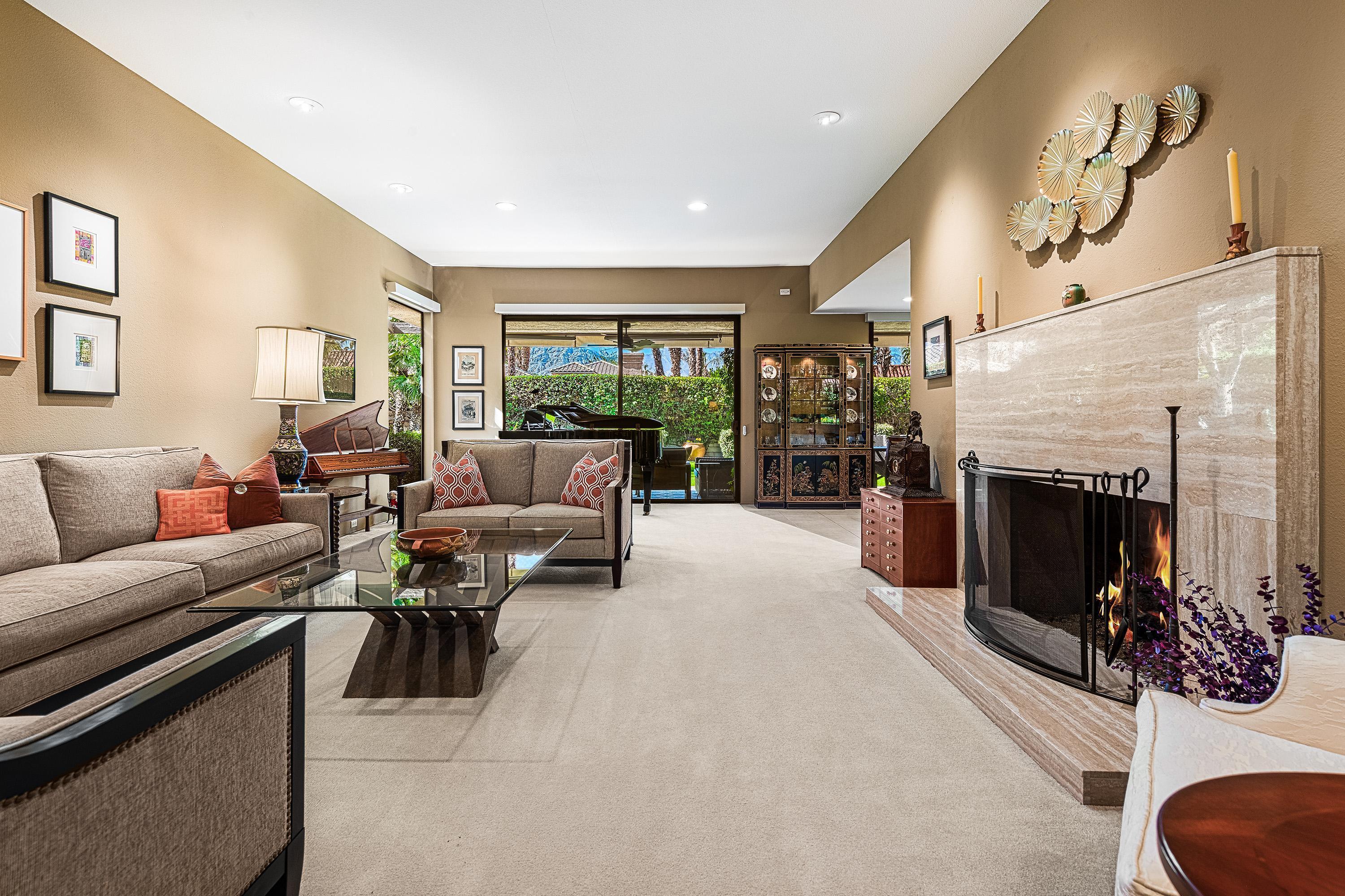 32 Cornell Drive Rancho Mirage, CA 92270 - Photo 2 of 50 a living room with furniture a fireplace and a flat screen tv