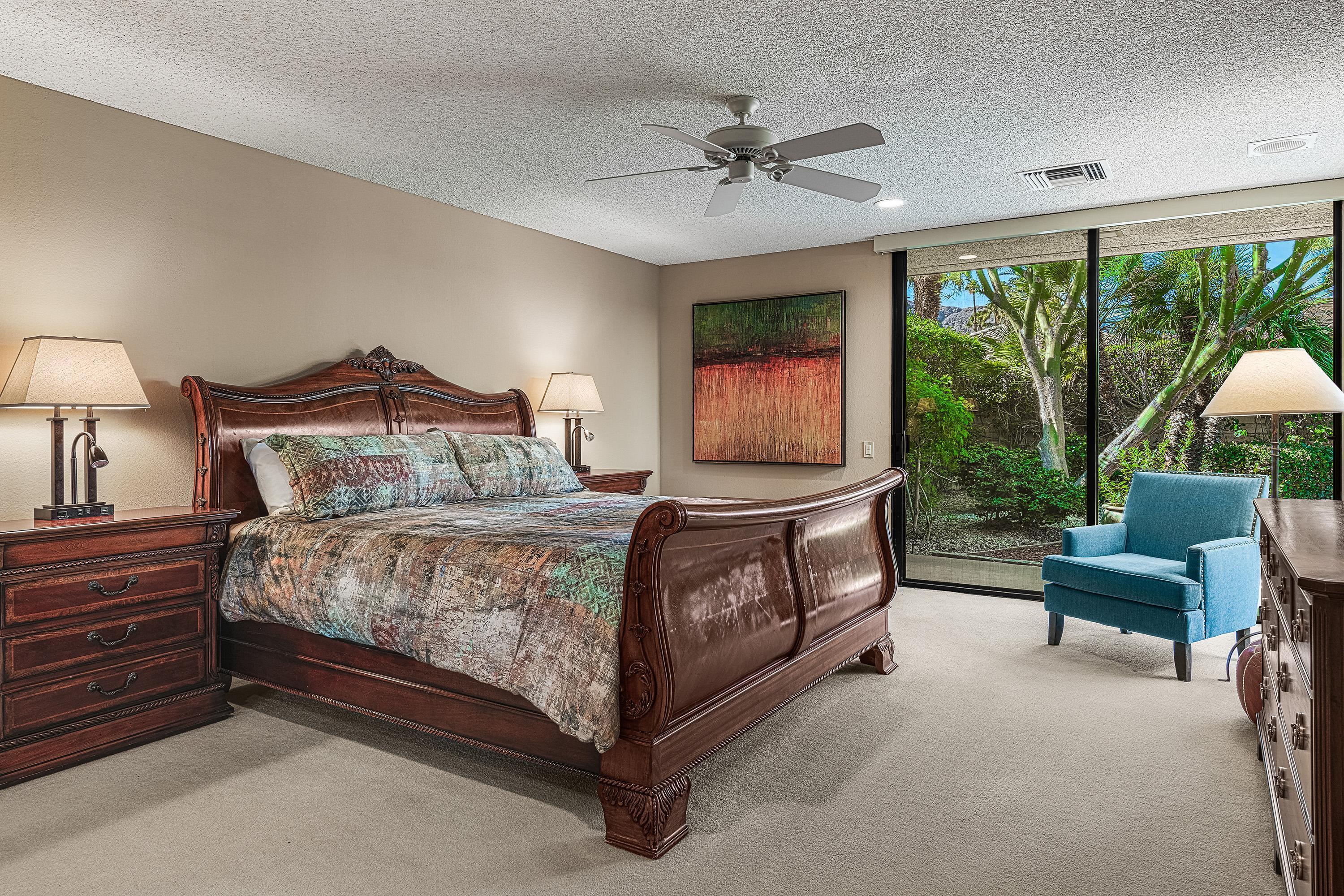 32 Cornell Drive Rancho Mirage, CA 92270 - Photo 27 of 50 a bedroom with a bed a couch and a large window