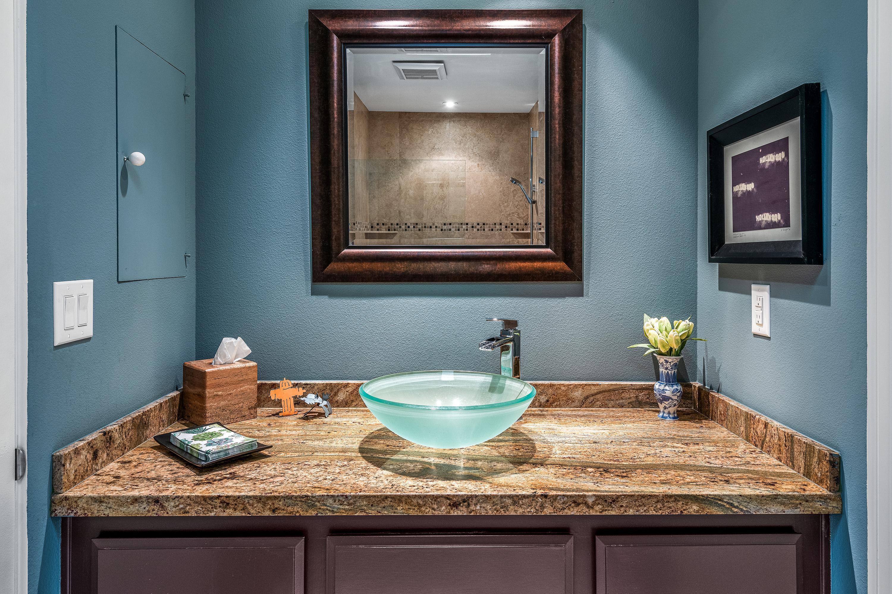32 Cornell Drive Rancho Mirage, CA 92270 - Photo 34 of 50 a bathroom with a granite countertop sink and a mirror