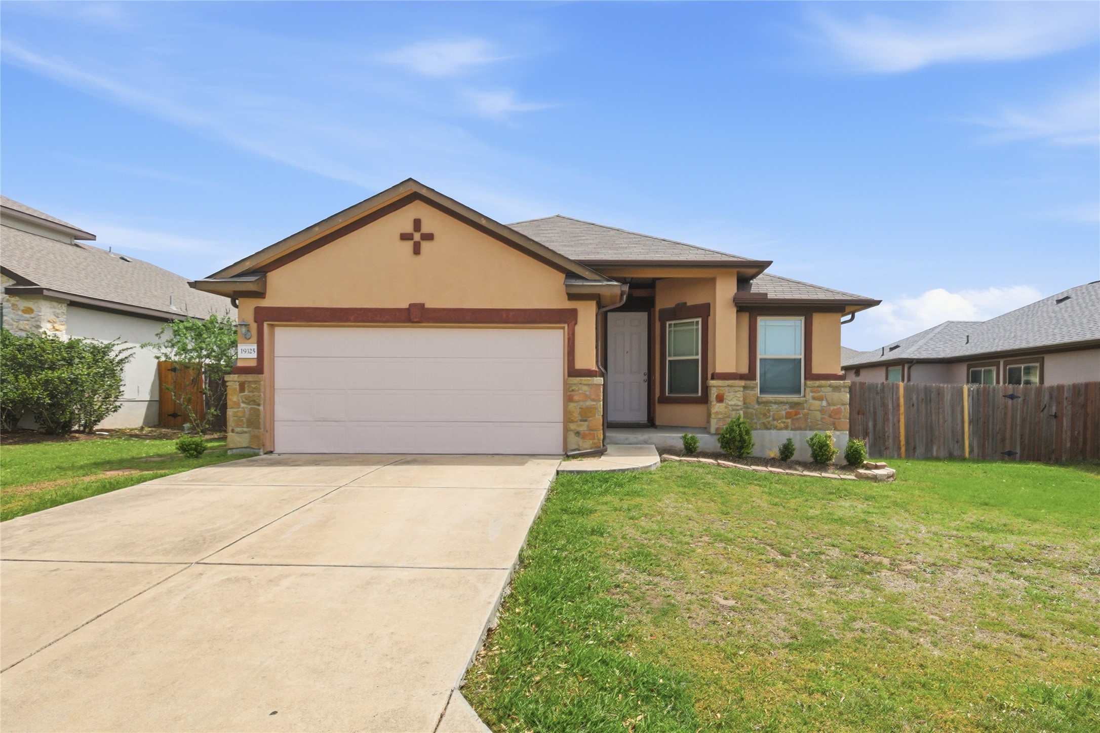 19325 Stokes Lane Pflugerville, TX 78660 - Photo 2 of 24 View of front of house featuring a garage, stucco siding, driveway, and stone siding