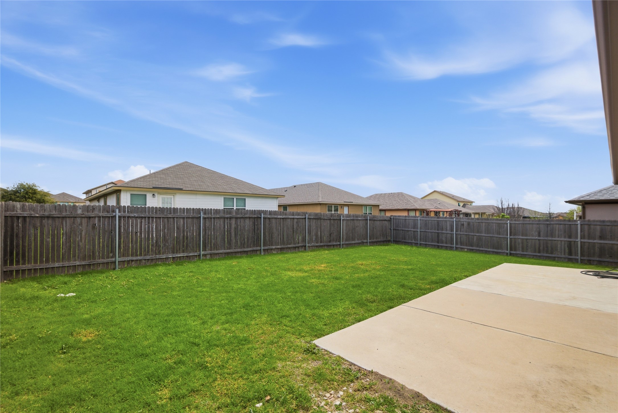 19325 Stokes Lane Pflugerville, TX 78660 - Photo 6 of 24 Fenced backyard featuring a patio and a residential view