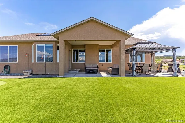 a view of a house with swimming pool and porch
