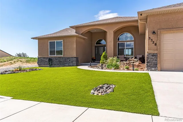 a front view of a house with garden