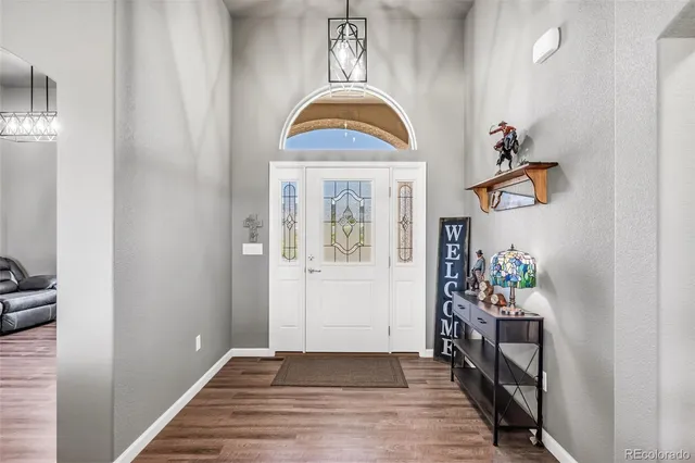 a view of an entryway with wooden floor