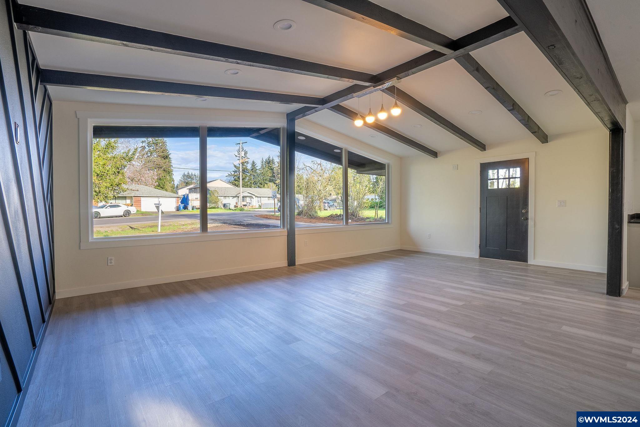 5085 Windsor Island Road North Keizer, OR 97303 - Photo 5 of 22 a view of an empty room with wooden floor and a window