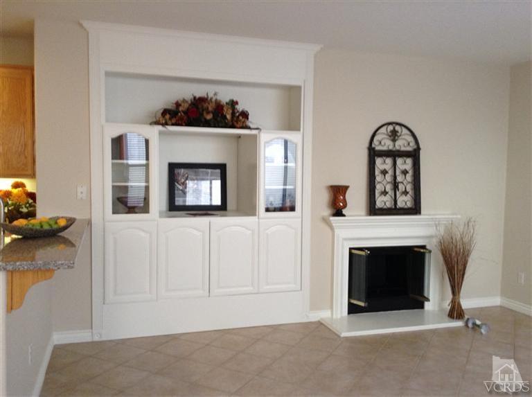 2564 Cloverleaf Lane Simi Valley, CA 93063 - Photo 12 of 30 a living room with a fireplace and a painting on the wall