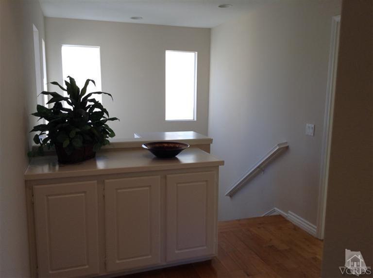 2564 Cloverleaf Lane Simi Valley, CA 93063 - Photo 14 of 30 a sink a mirror and wooden floor