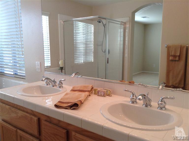 2564 Cloverleaf Lane Simi Valley, CA 93063 - Photo 17 of 30 a bathroom with double vanity sinks and a mirror