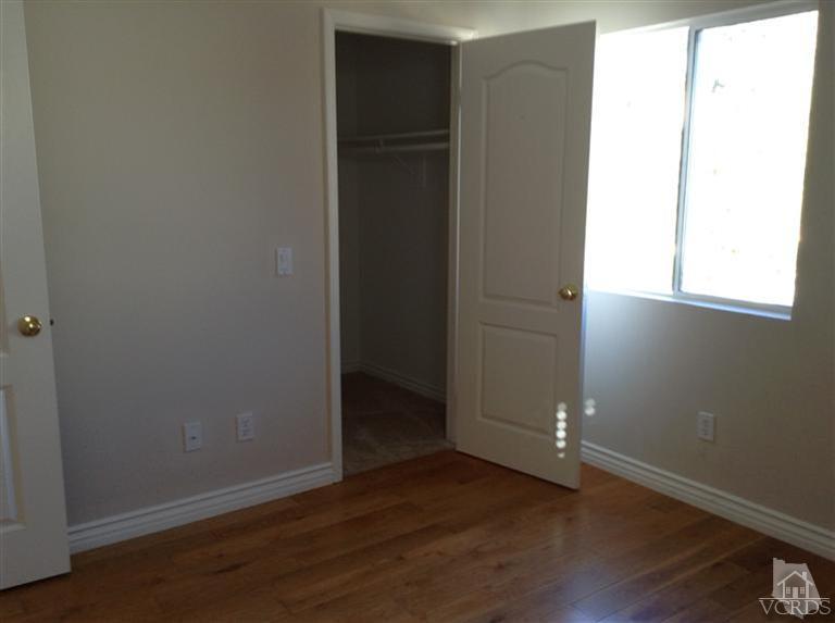 2564 Cloverleaf Lane Simi Valley, CA 93063 - Photo 22 of 30 an empty room with wooden floor and windows