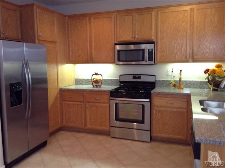 2564 Cloverleaf Lane Simi Valley, CA 93063 - Photo 7 of 30 a kitchen with a refrigerator stove and microwave