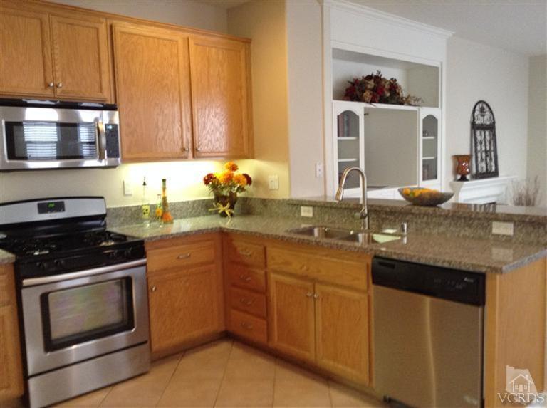 2564 Cloverleaf Lane Simi Valley, CA 93063 - Photo 8 of 30 a kitchen with granite countertop stainless steel appliances a stove sink and cabinets