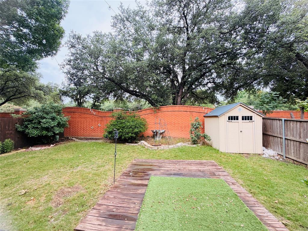 434 Moonlight Way Irving, TX 75063 - Photo 24 of 29 a front view of a house with a yard and garage
