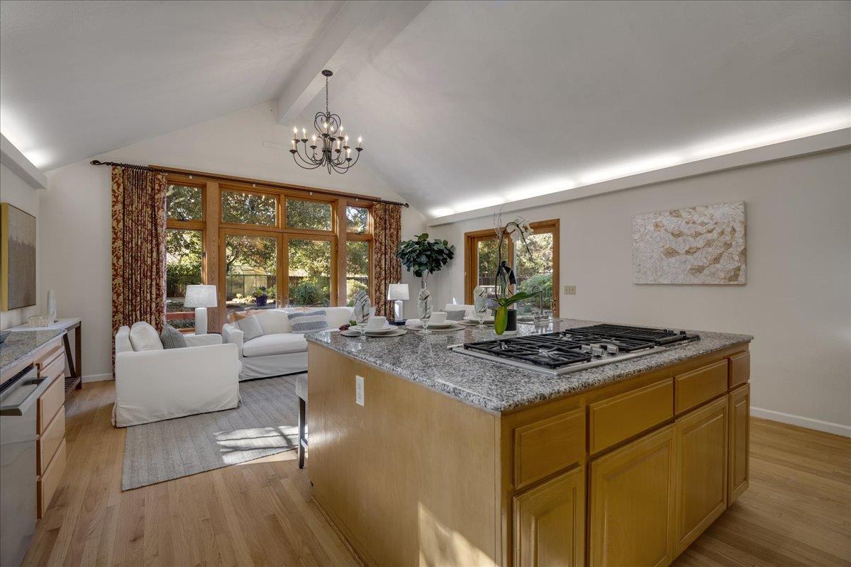 1034 Parma Way Los Altos, CA 94024 - Photo 21 of 49 a view of kitchen island with stainless steel appliances granite countertop a stove a sink dishwasher a dining table and chair with wooden floor