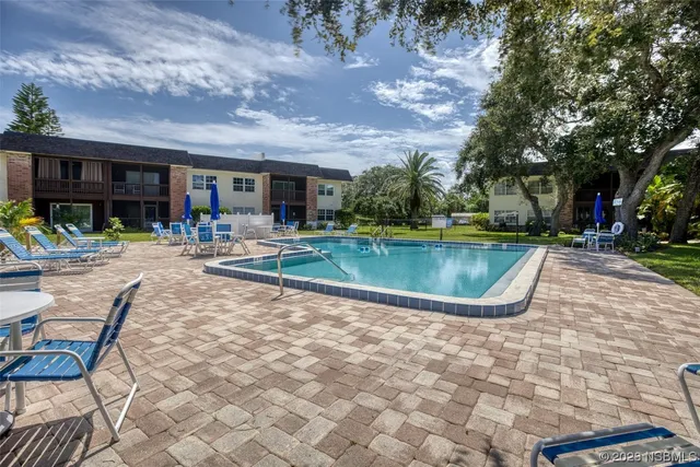 a view of a swimming pool with sitting area
