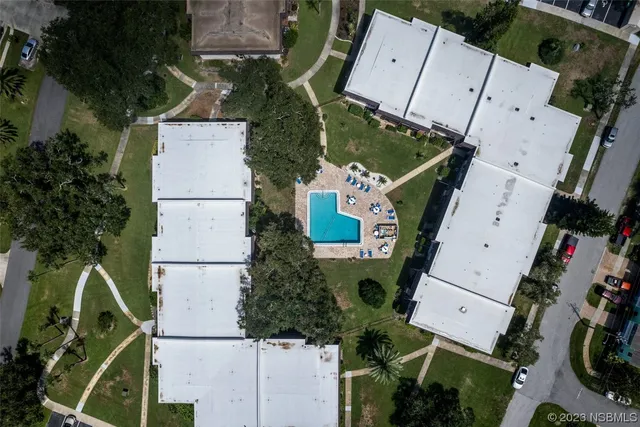 an aerial view of houses with yard