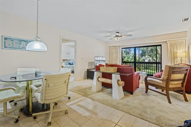 a living room with furniture a window and a table