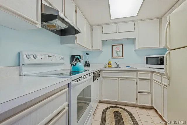 a utility room with cabinets washer and dryer