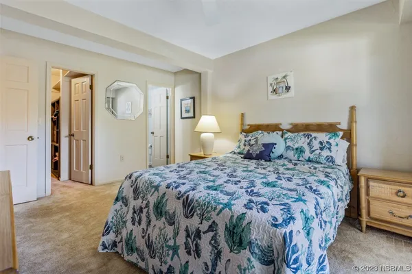 a bedroom with a bed and a lamp