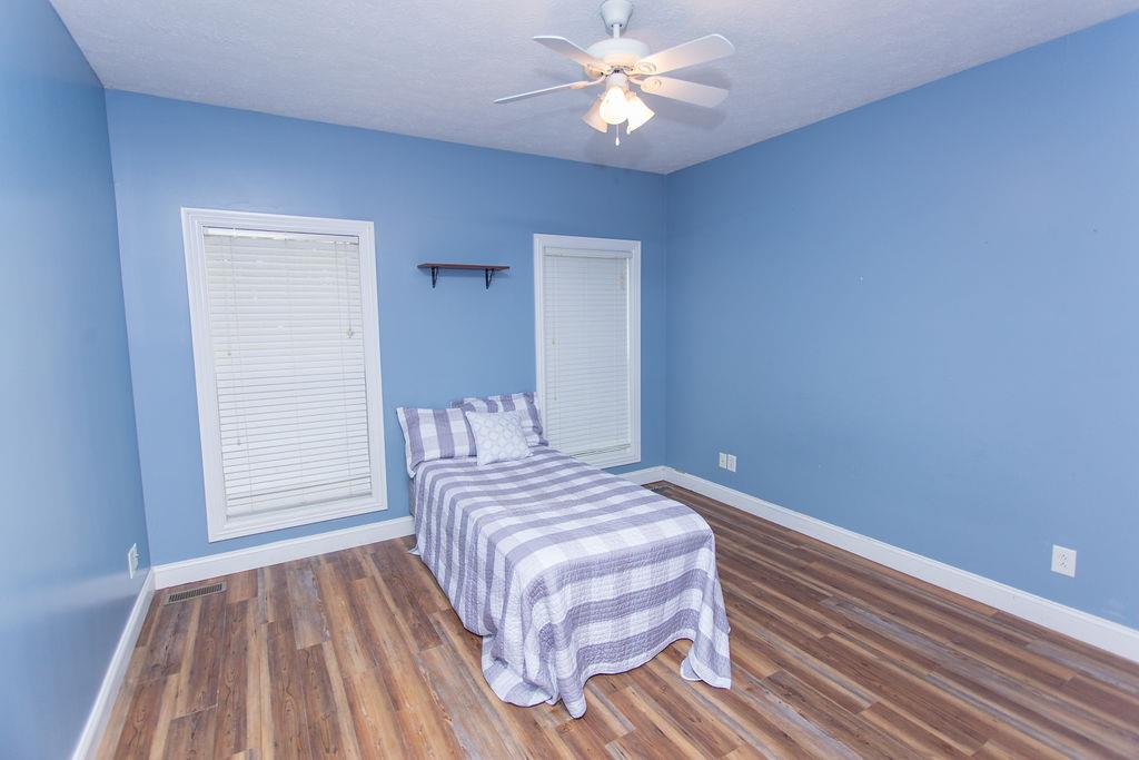 1009 Lake Rise Overlook Gallatin, TN 37066 - Photo 13 of 20 a bedroom with a bed and a chandelier