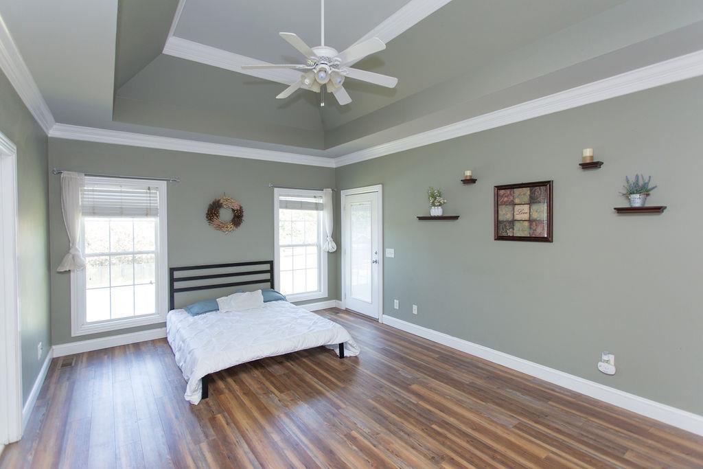 1009 Lake Rise Overlook Gallatin, TN 37066 - Photo 4 of 20 an empty room with wooden floor chandelier fan and windows