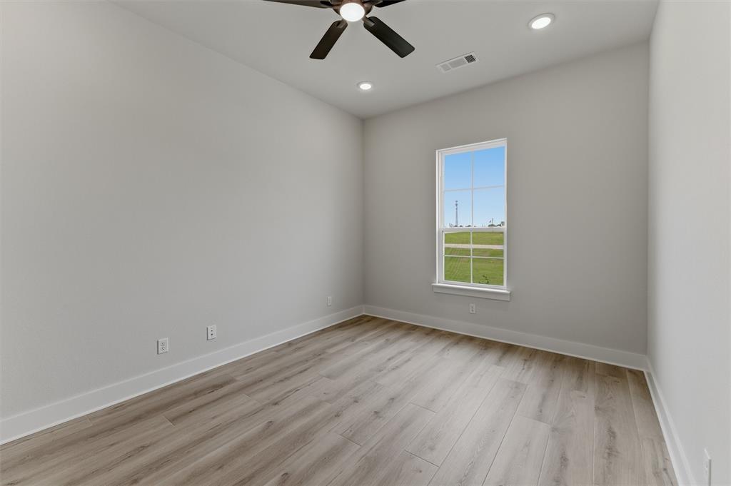2204 Continent Court Krum, TX 76249 - Photo 7 of 28 Bright interior space featuring a window with exterior views, wood-finish flooring, a ceiling fan, and recessed lighting