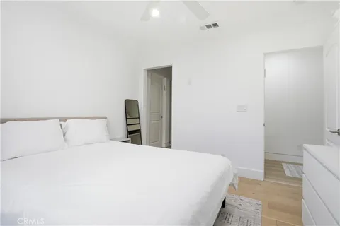 a bedroom with a bed and a night stand