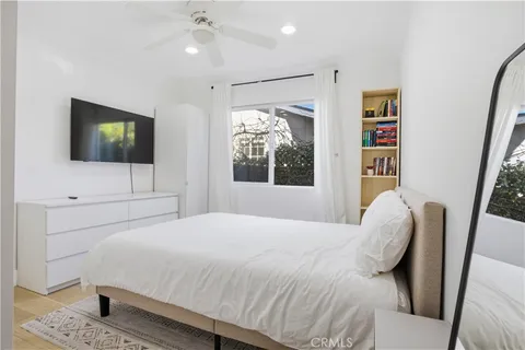 a bedroom with a bed and a flat screen tv