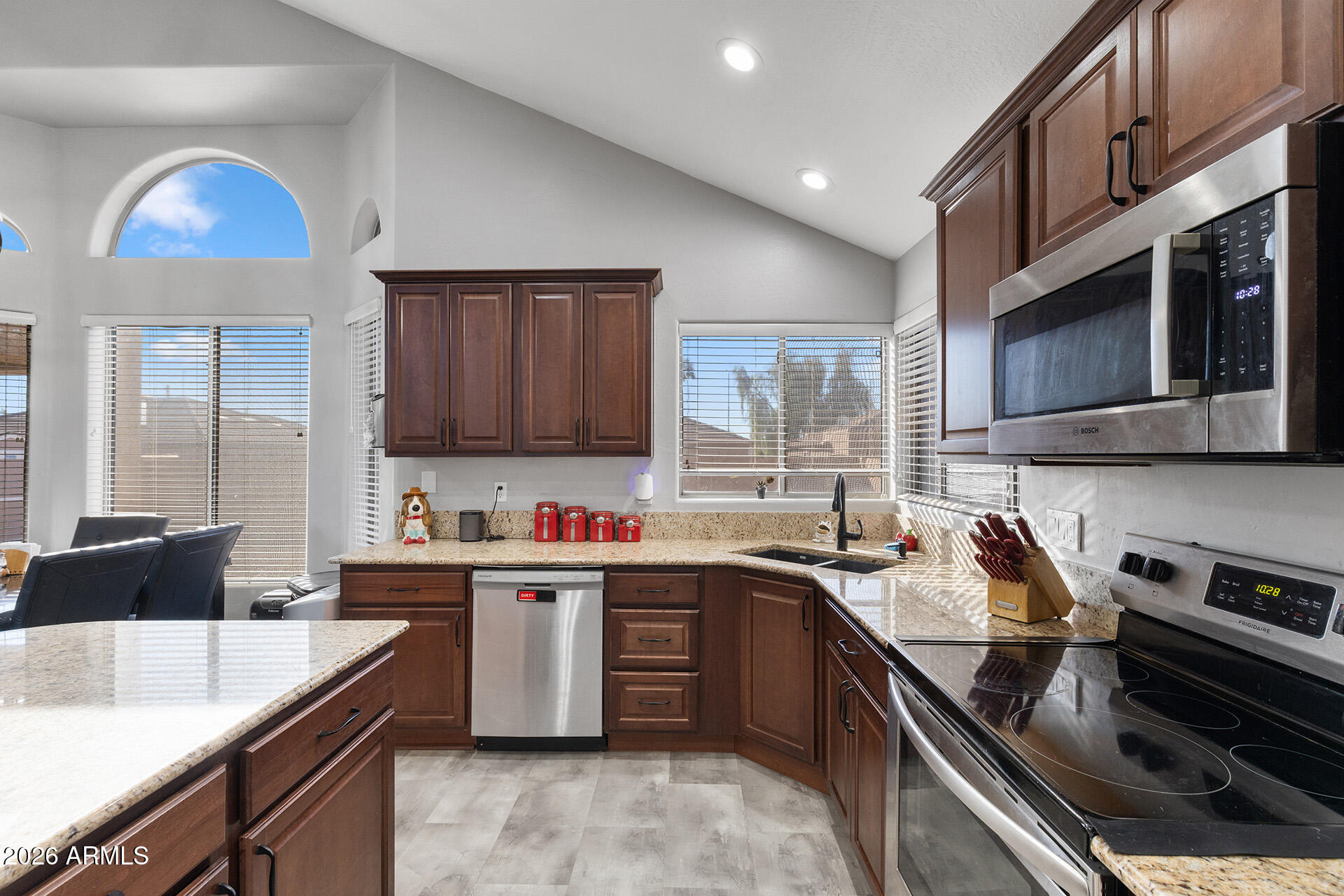 11029 East Decatur Street Mesa, AZ 85207 - Photo 26 of 62 a kitchen with stainless steel appliances granite countertop a sink stove and microwave