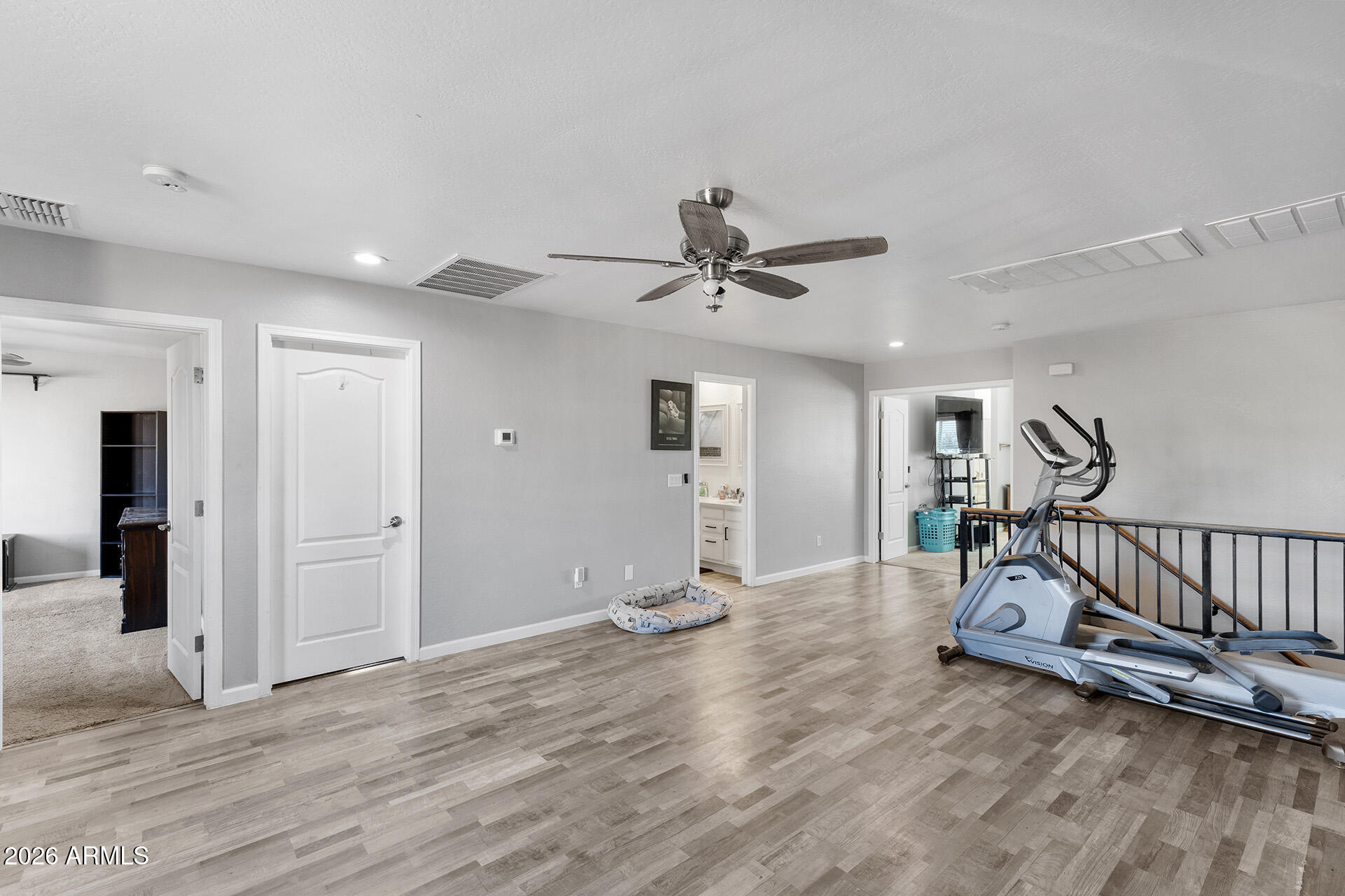11029 East Decatur Street Mesa, AZ 85207 - Photo 32 of 62 a view of a livingroom with wooden floor and a ceiling fan