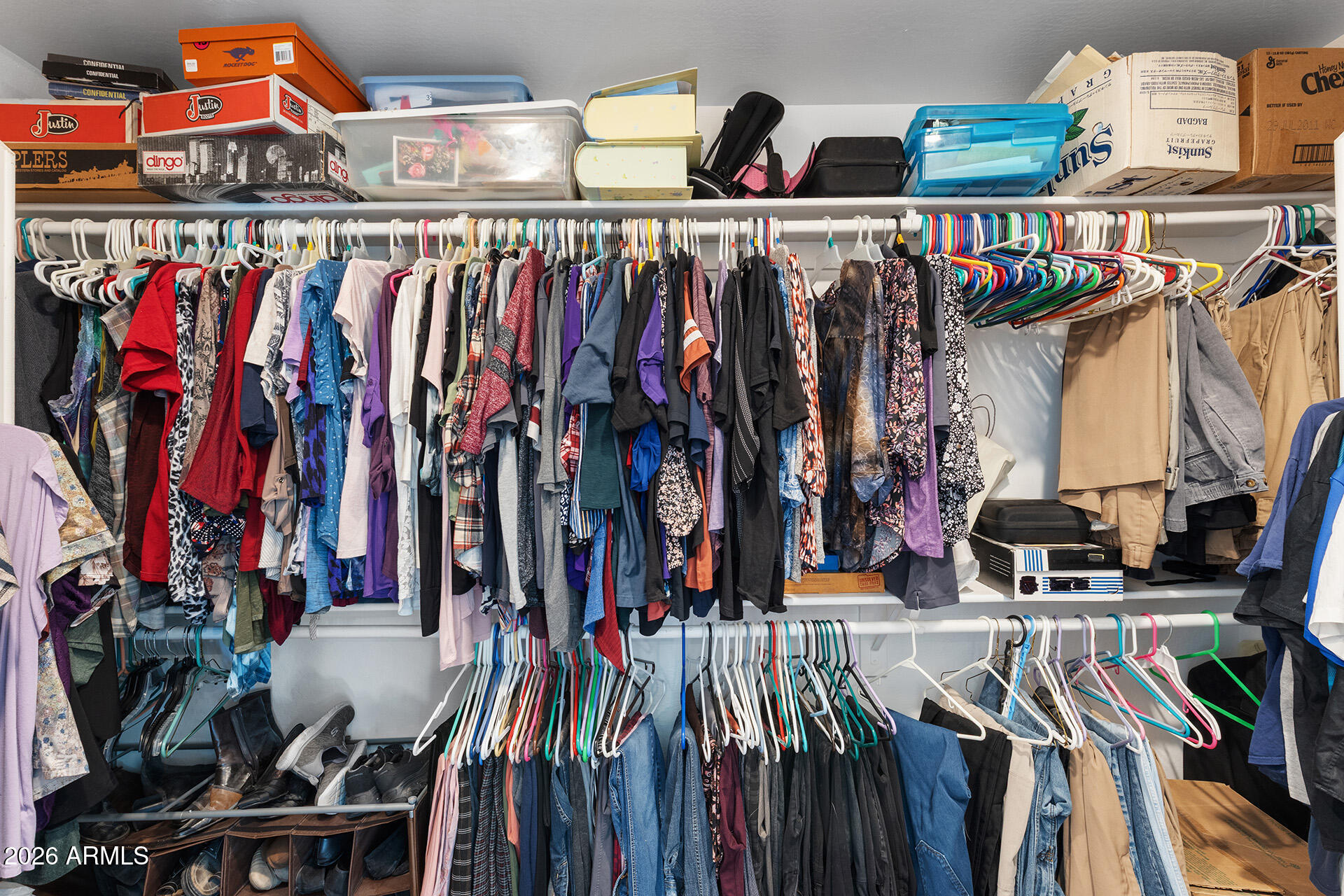 11029 East Decatur Street Mesa, AZ 85207 - Photo 50 of 62 a view of walk in closet with clothes and shoes