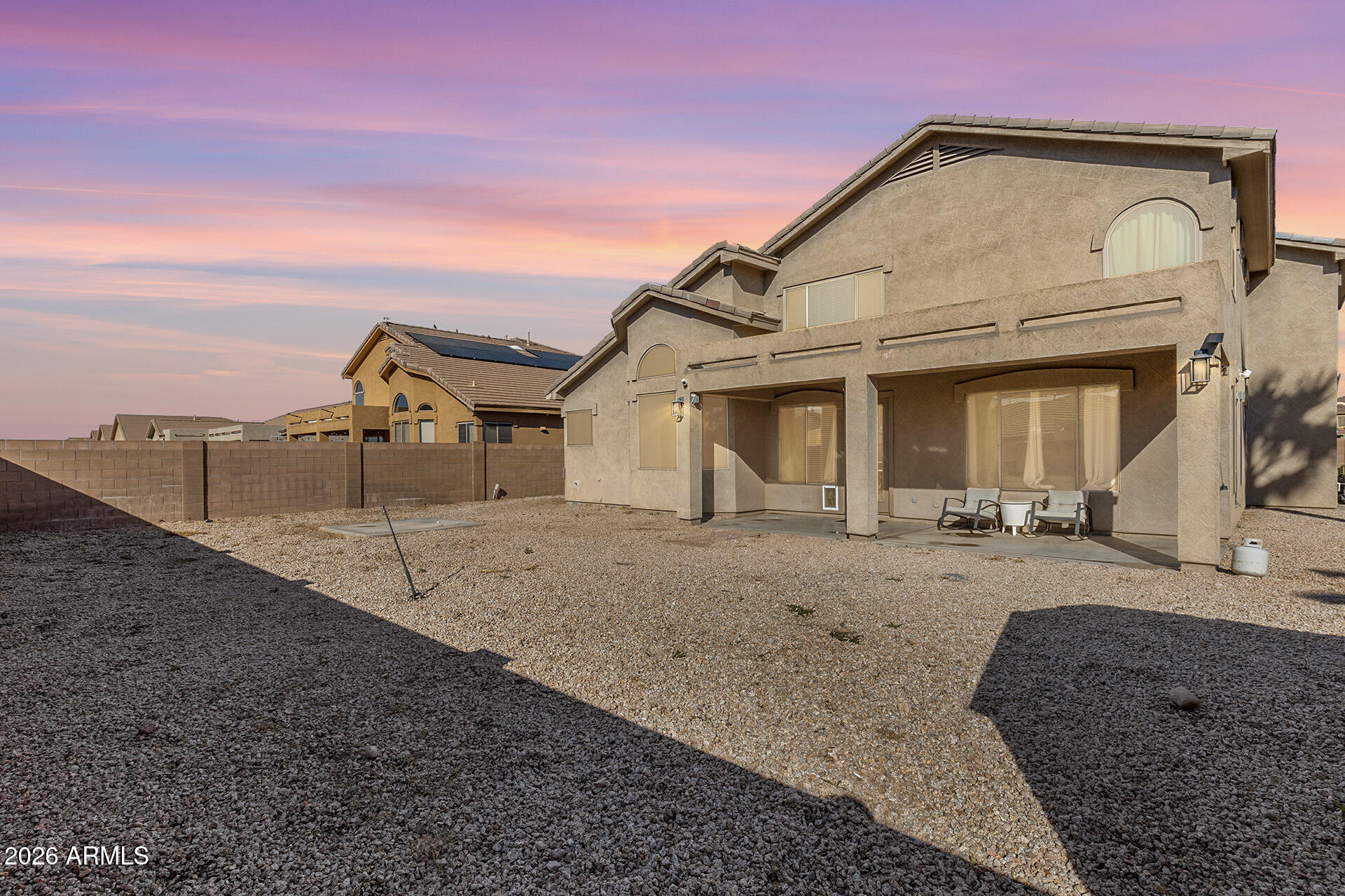 11029 East Decatur Street Mesa, AZ 85207 - Photo 60 of 62 a view of a house with a dry space and wooden fence