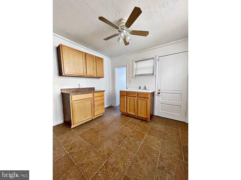 1110 Maple Street Wilmington, DE 19805 - Photo 4 of 10 a living room with stainless steel appliances kitchen island granite countertop furniture and a ceiling fan